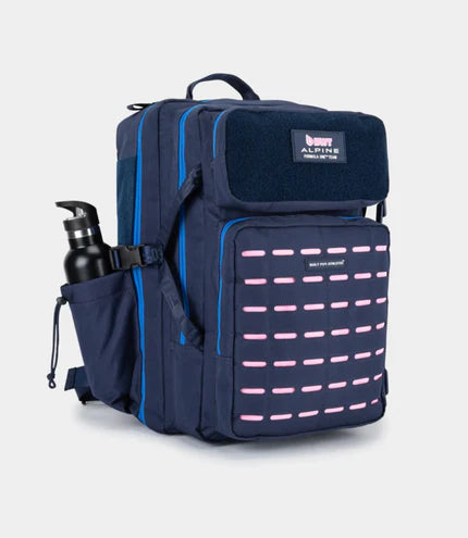 Full side view of the navy blue Built for Athletes 45L tactical backpack showing the BWT Alpine F1 Team patch, pink laser-cut loops, and a water bottle in the side pocket.