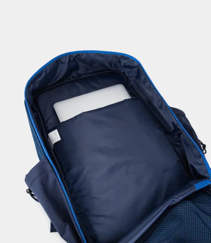Navy blue backpack with a white item inside on a light gray background