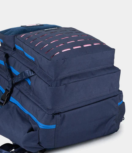 Navy blue backpack with blue zippers on a light gray background