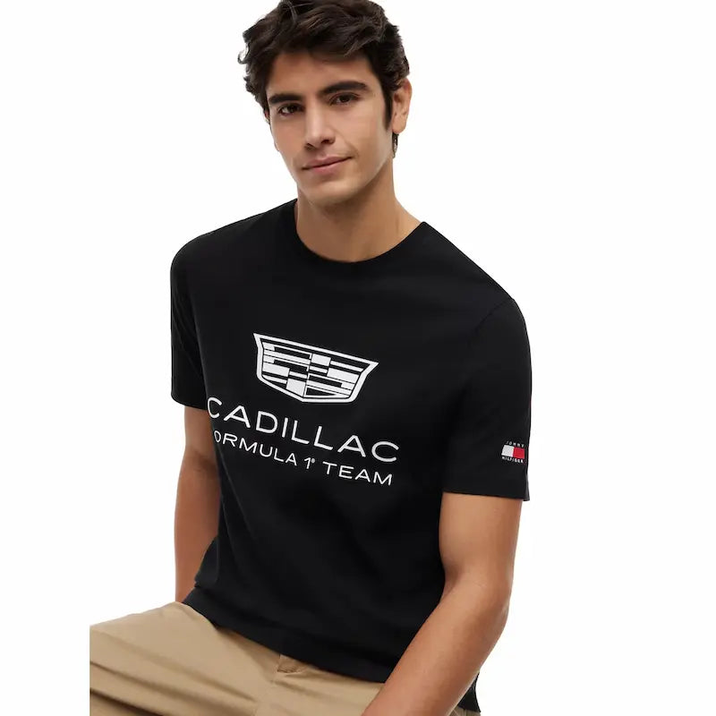 Close-up of the Tommy Hilfiger flag logo on the sleeve and the signature red, white, and blue neck trim of the 2026 Cadillac F1 fanwear.