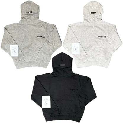 Three hoodies in gray, black, and white with 'ESSENTIALS' branding on a white background.