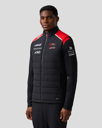 Front view of Haas F1 Team inspired unisex gilet in black with red and white shoulder accents by TassFit Performance