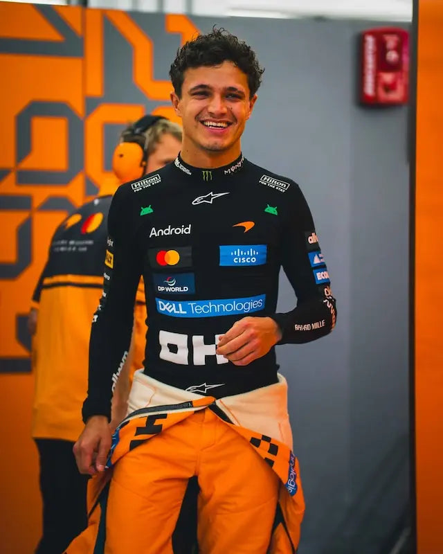 Front view of Lando Norris 2026 McLaren F1 World Champion compression shirt in anthracite grey and papaya orange with the number 1 and OKX branding.