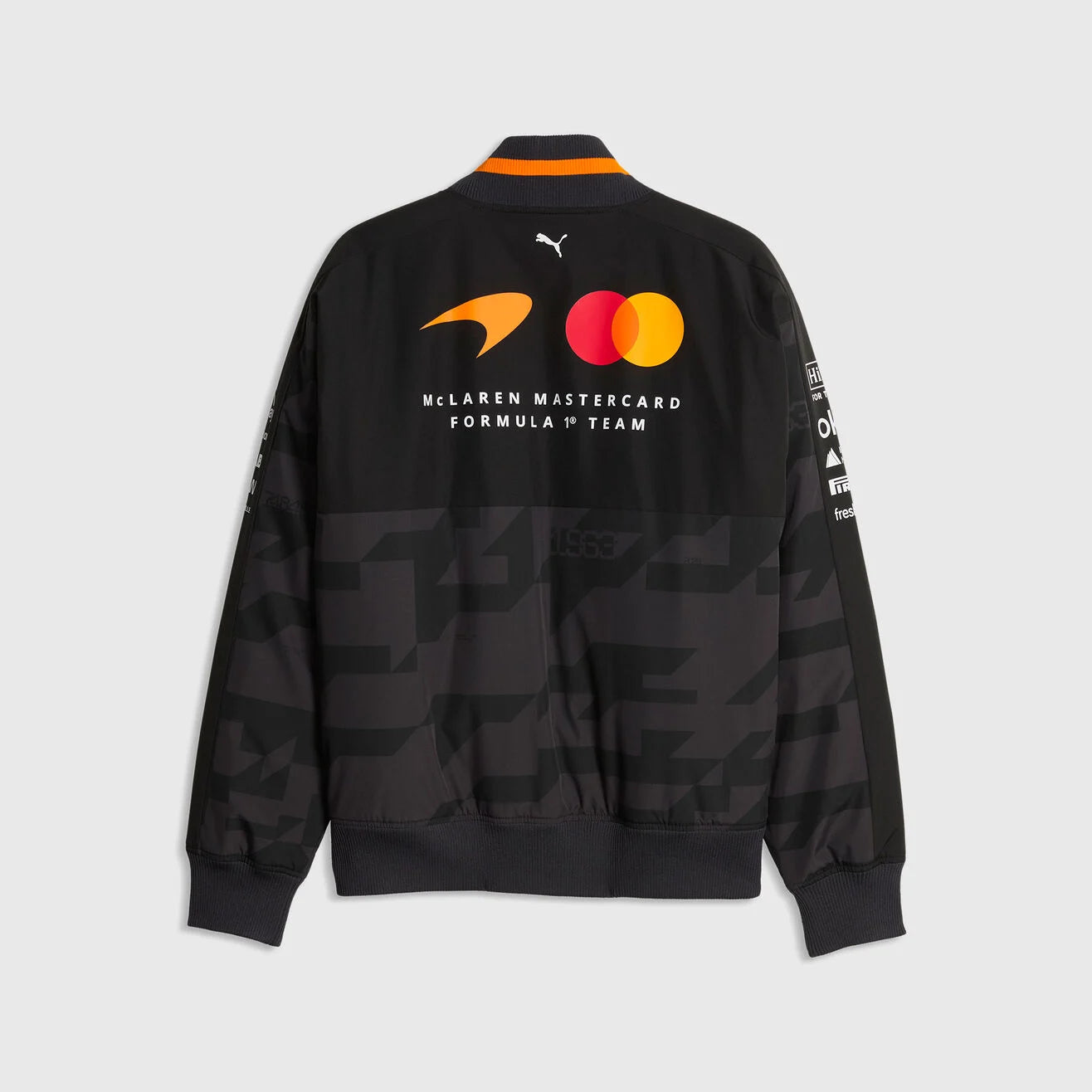 Back view of the McLaren 1000th GP bomber jacket showing the prominent McLaren Mastercard Formula 1 Team logo and Puma cat silhouette on the upper back.