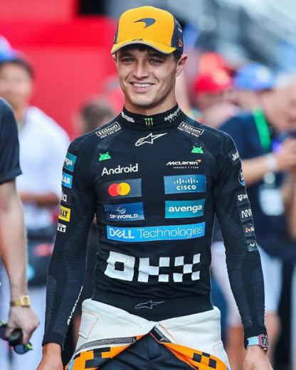 Lando wearing a racing suit with various sponsor logos at an event